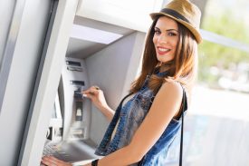 Woman using ATM machine